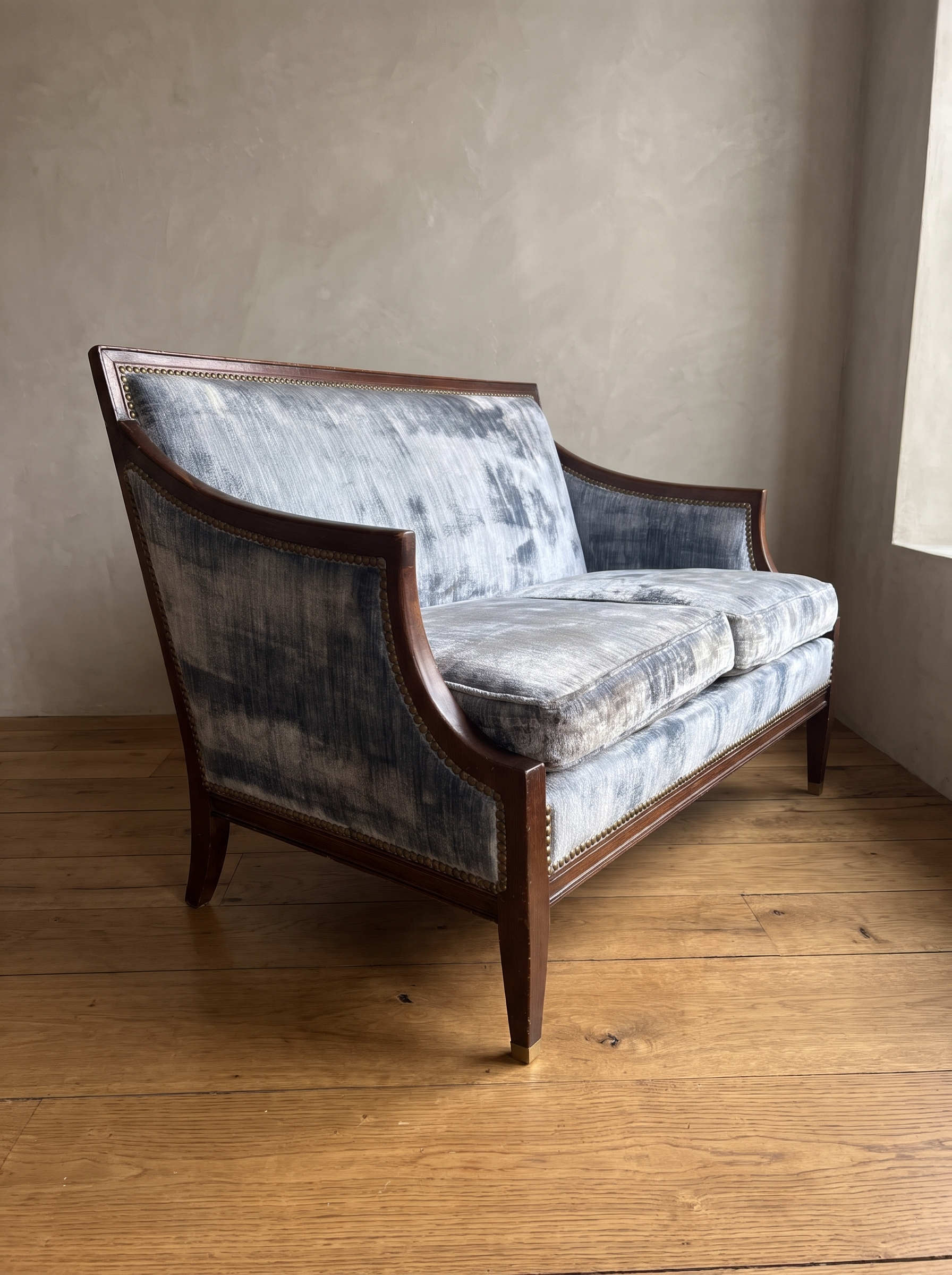 Ice blue velvet loveseat, three-quarter view from the right showing the sabre arm