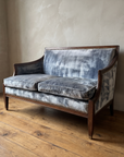 Ice blue velvet loveseat, angled view along the arm