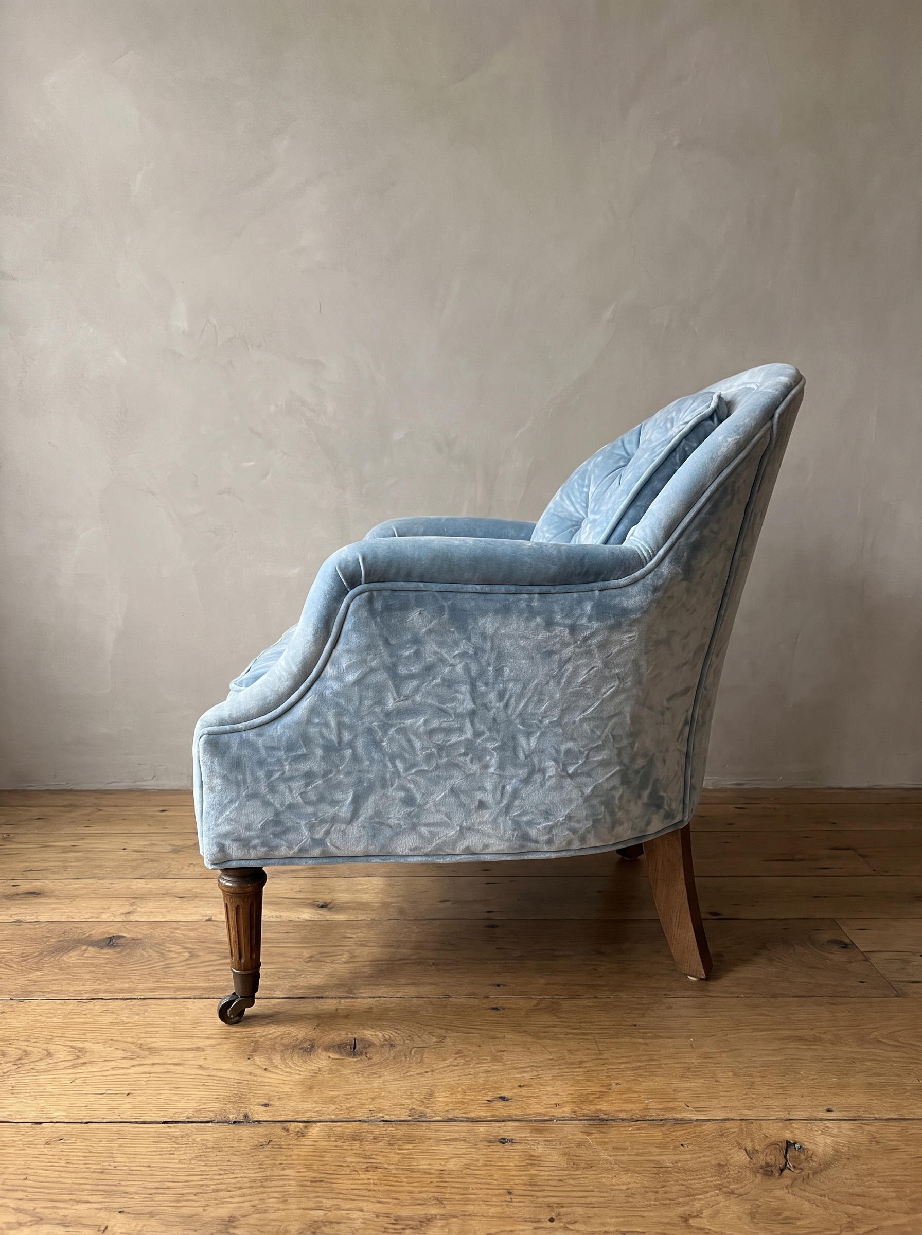 Powder blue velvet tub chair, side profile