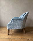 Powder blue velvet tub chair, side profile