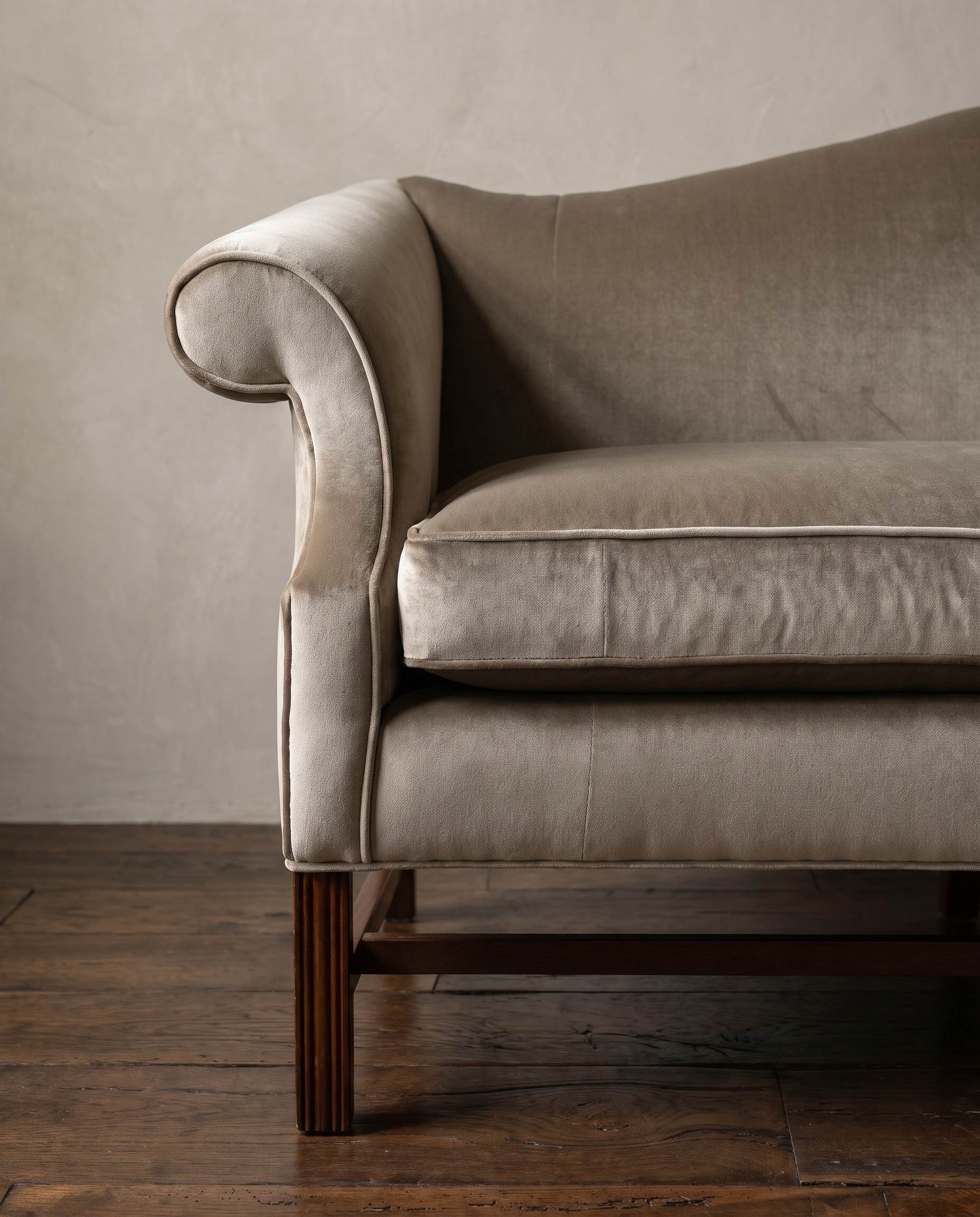 Detail of the piped scroll arm in mushroom tan velvet