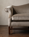 Detail of the piped scroll arm in mushroom tan velvet
