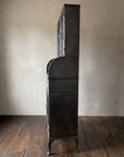 Side profile of the steel hutch showing its shallow 16 inch depth and curved gallery panel