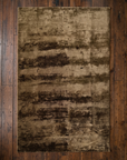 Overhead view of the full 5x8 olive and brown abstract Ralph Lauren rug on wide plank floor