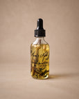 Jasmine + Sandalwood Aromatic Body Oil by Mum's Milk, glass dropper bottle with jasmine buds and sandalwood