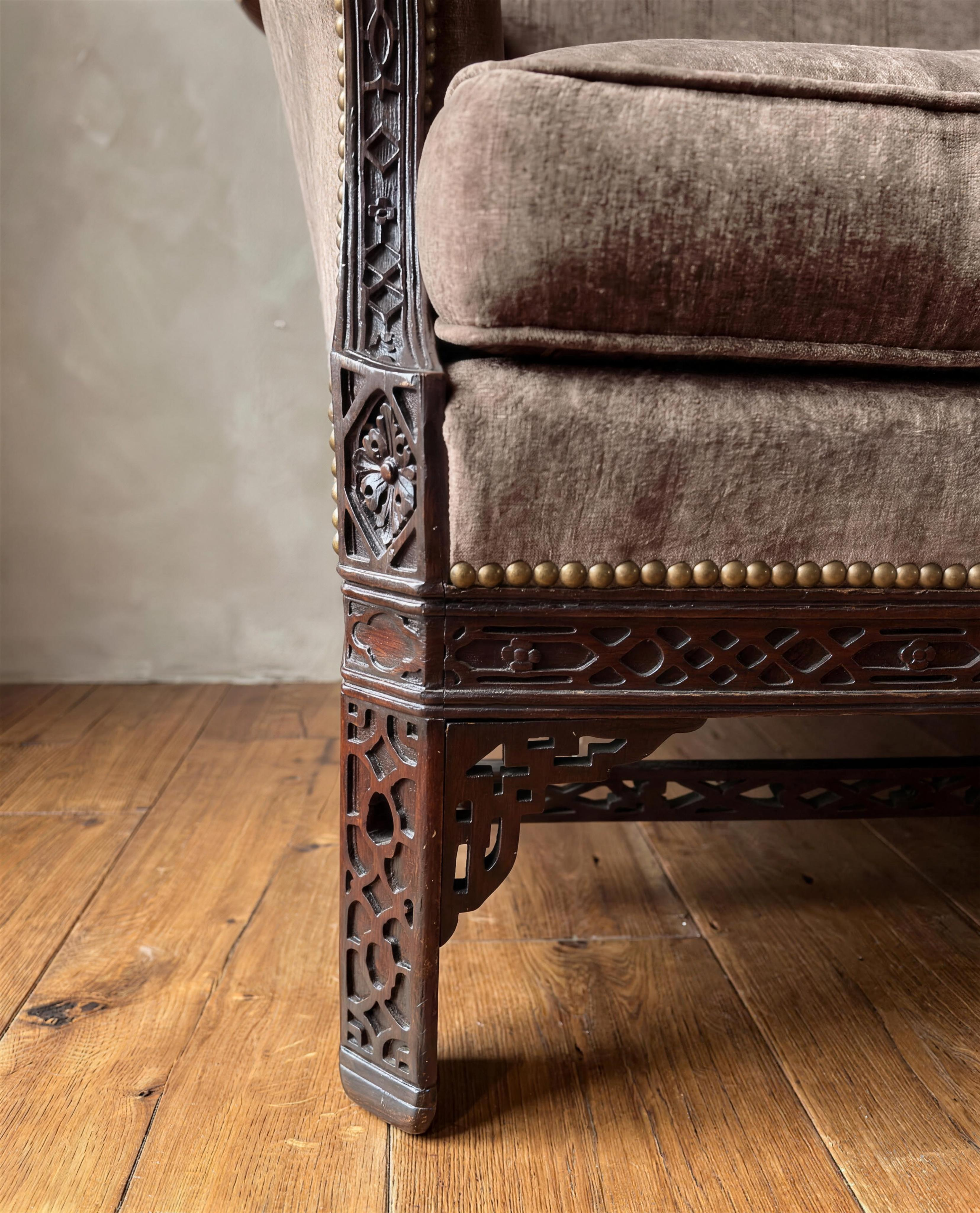 Detail of carved rosette corner block, pierced fretwork leg and brass nailheads
