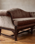 Low angle along the sofa from the high pleated scroll arm