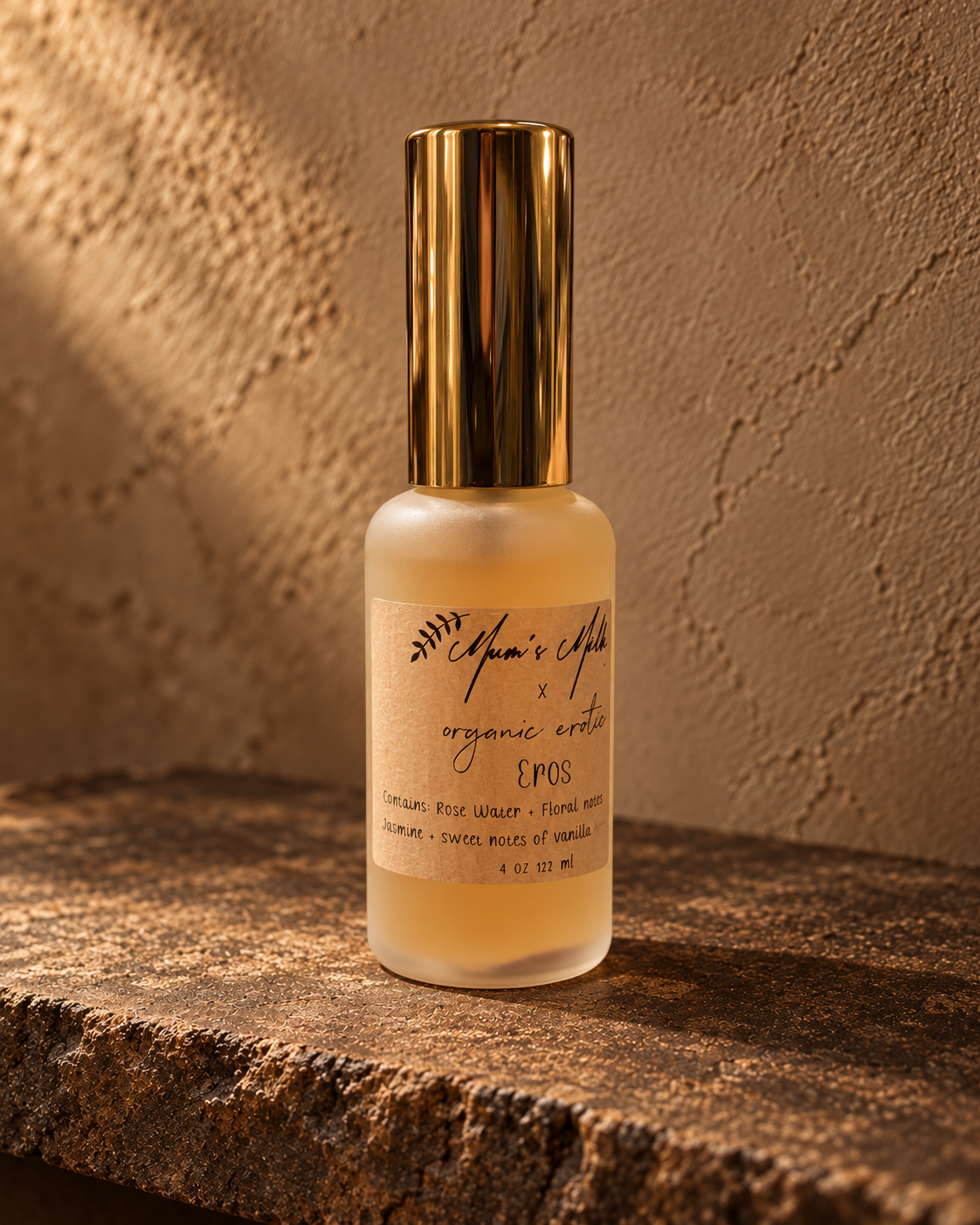 Mum's Milk x Organic Erotic Eros bottle on weathered stone against warm taupe plaster