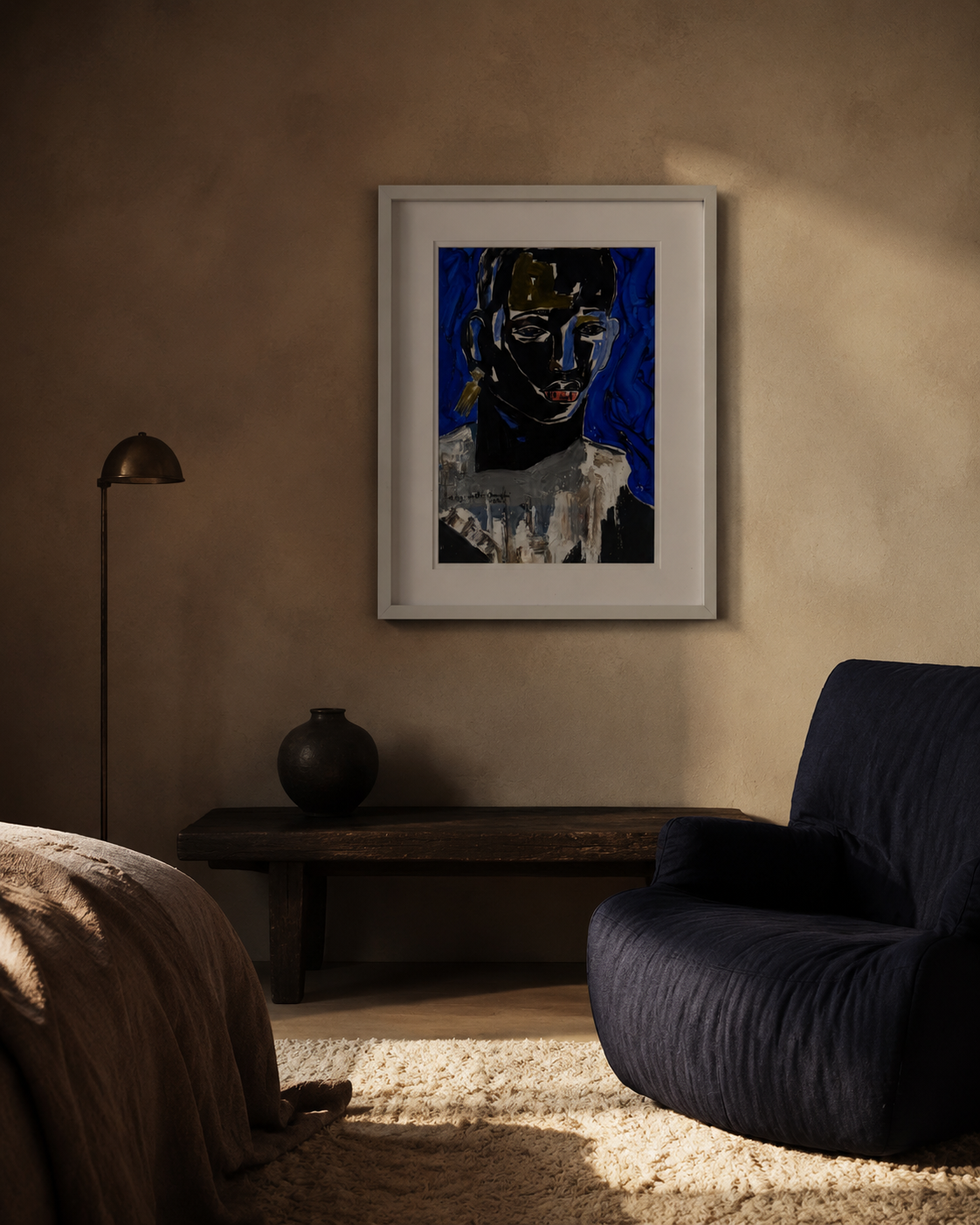 Framed blue and gold portrait hung above a dark bench in a warm plaster bedroom