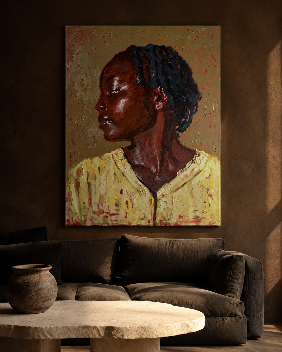 Portrait in profile of a woman in a yellow shirt, hung above a dark linen sofa in a warm plaster room