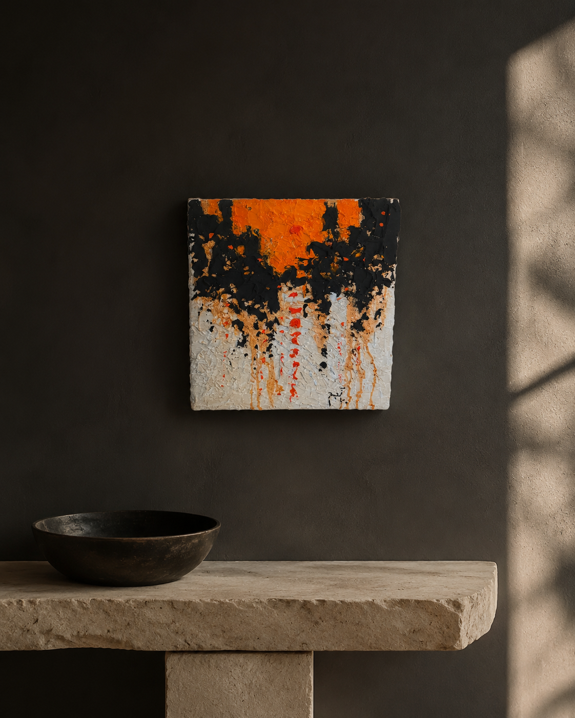 Small orange black and white impasto painting hung above a stone bench in a dark plaster room