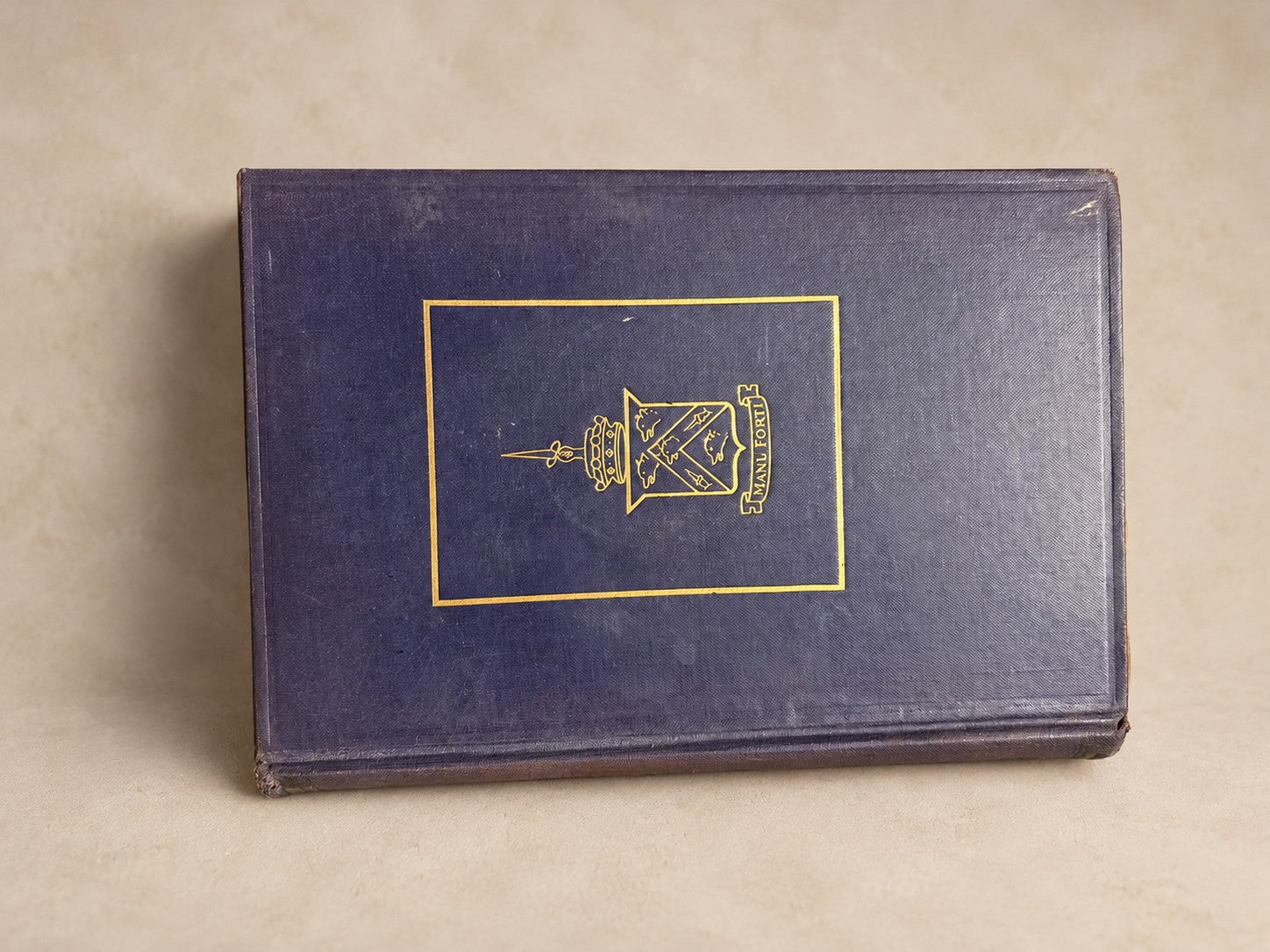Antique book in violet cloth with a gilt lantern device