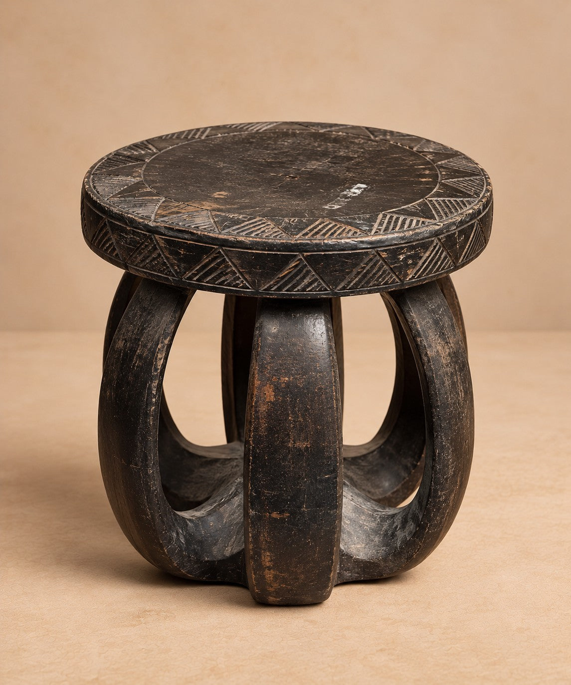 Carved blackwood stool with arched openwork legs and incised rim, Organic Erotic