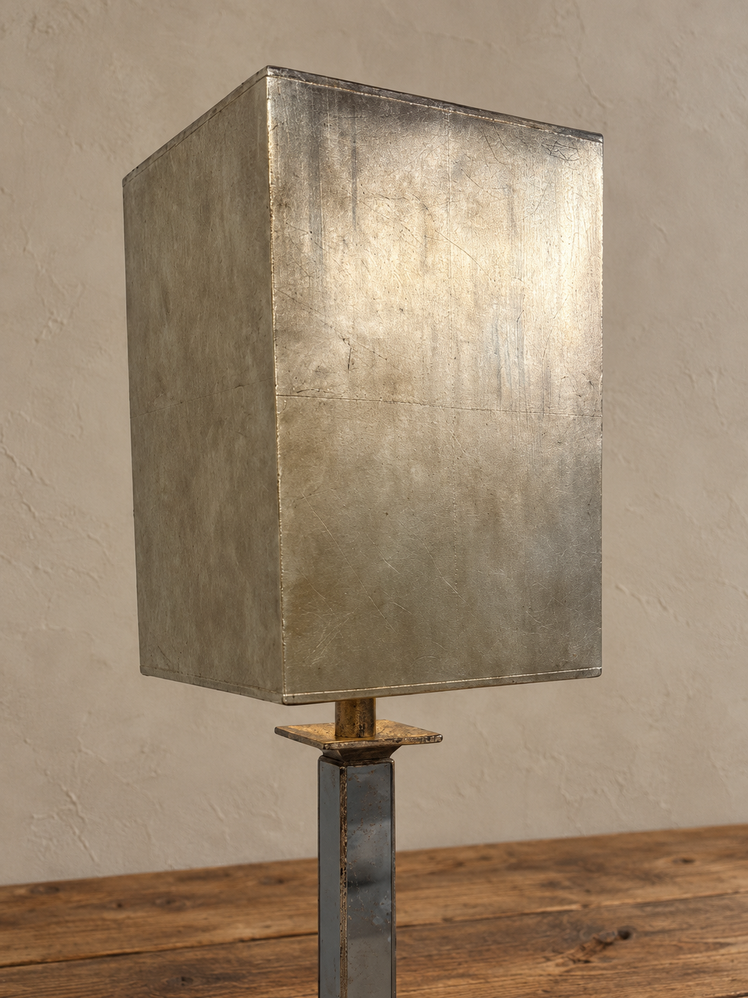Close view of the tall silver-toned rectangular shade and upper mirrored stem