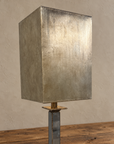 Close view of the tall silver-toned rectangular shade and upper mirrored stem