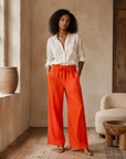 Orange linen drawstring pants on model