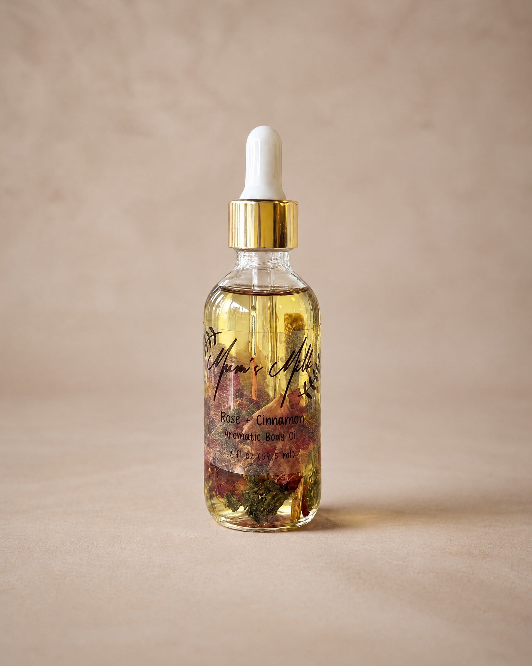 Rose + Cinnamon Aromatic Body Oil by Mum's Milk, glass dropper bottle with rose petals and cinnamon bark